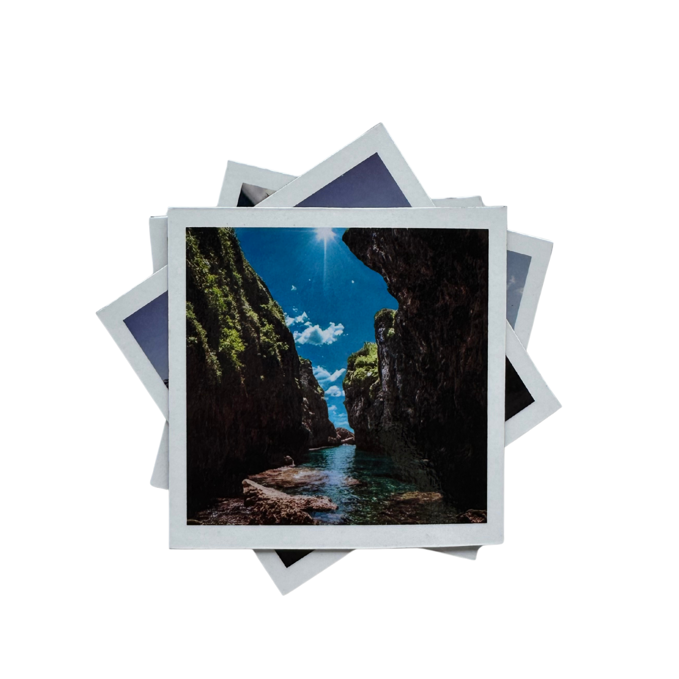 Stack of magnetic photo prints with a scenic view of a canyon.
