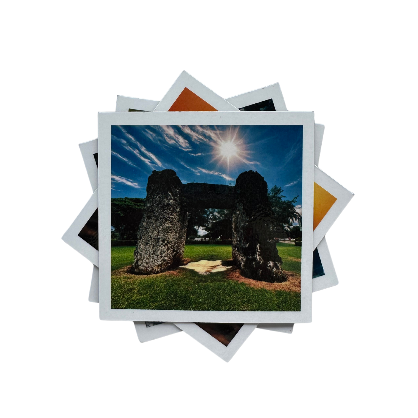 Stack of magnetic photo prints with a scenic landscape featuring stone structures and a sunlit sky.
